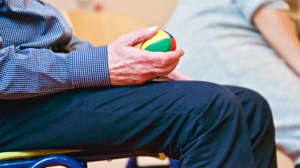 Senior holding a therapy ball